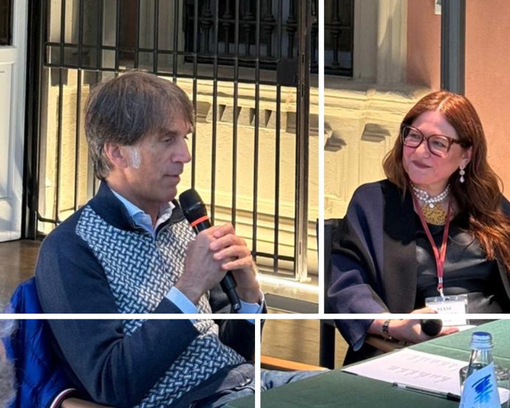 Davide Oldani speaking during a K.hub Journey event while seated beside the moderator during a discussion on excellence, discipline, and accessibility.